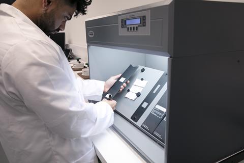 Staff member operating a machine at Boohoo Lab Manchester